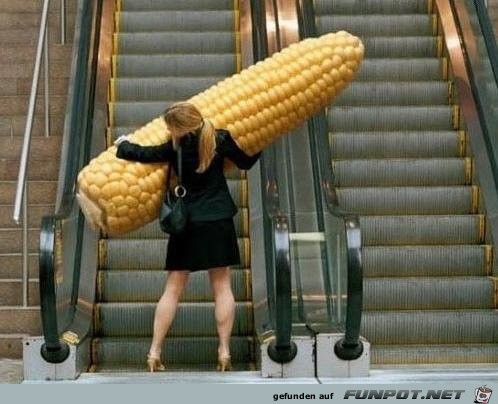 A-woman-trying-to-get-her-corn-up-the-escalator